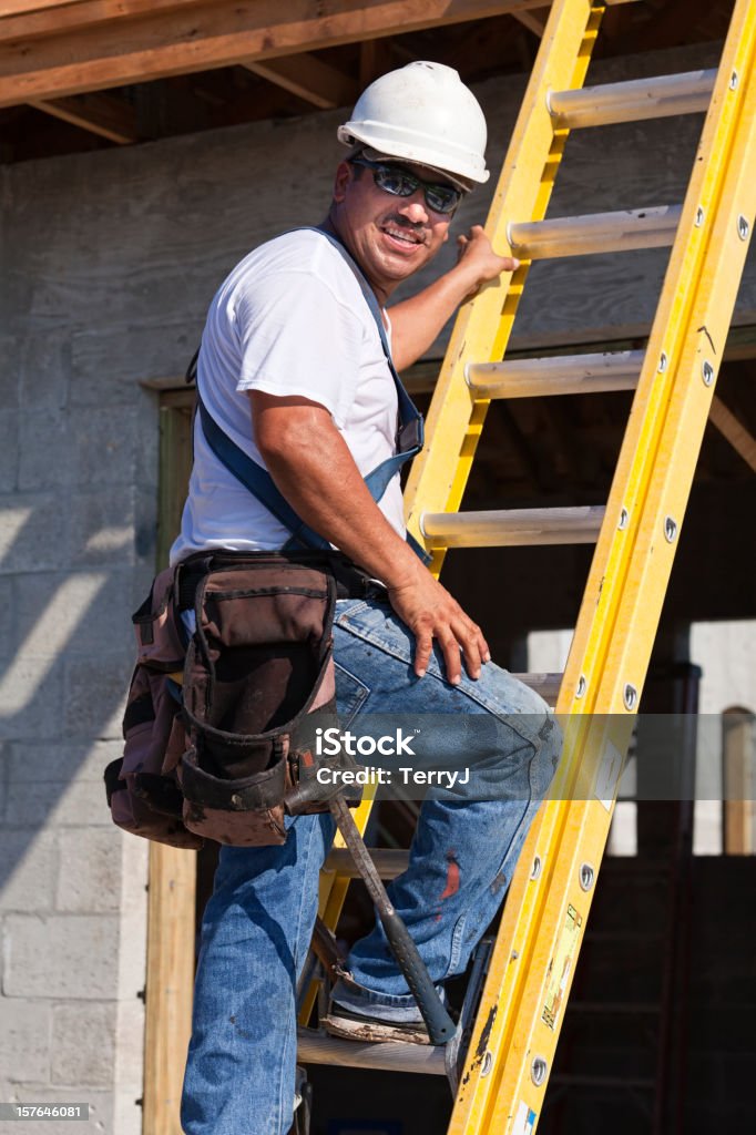 Roofer preparing to go up a ladder to install a roof.